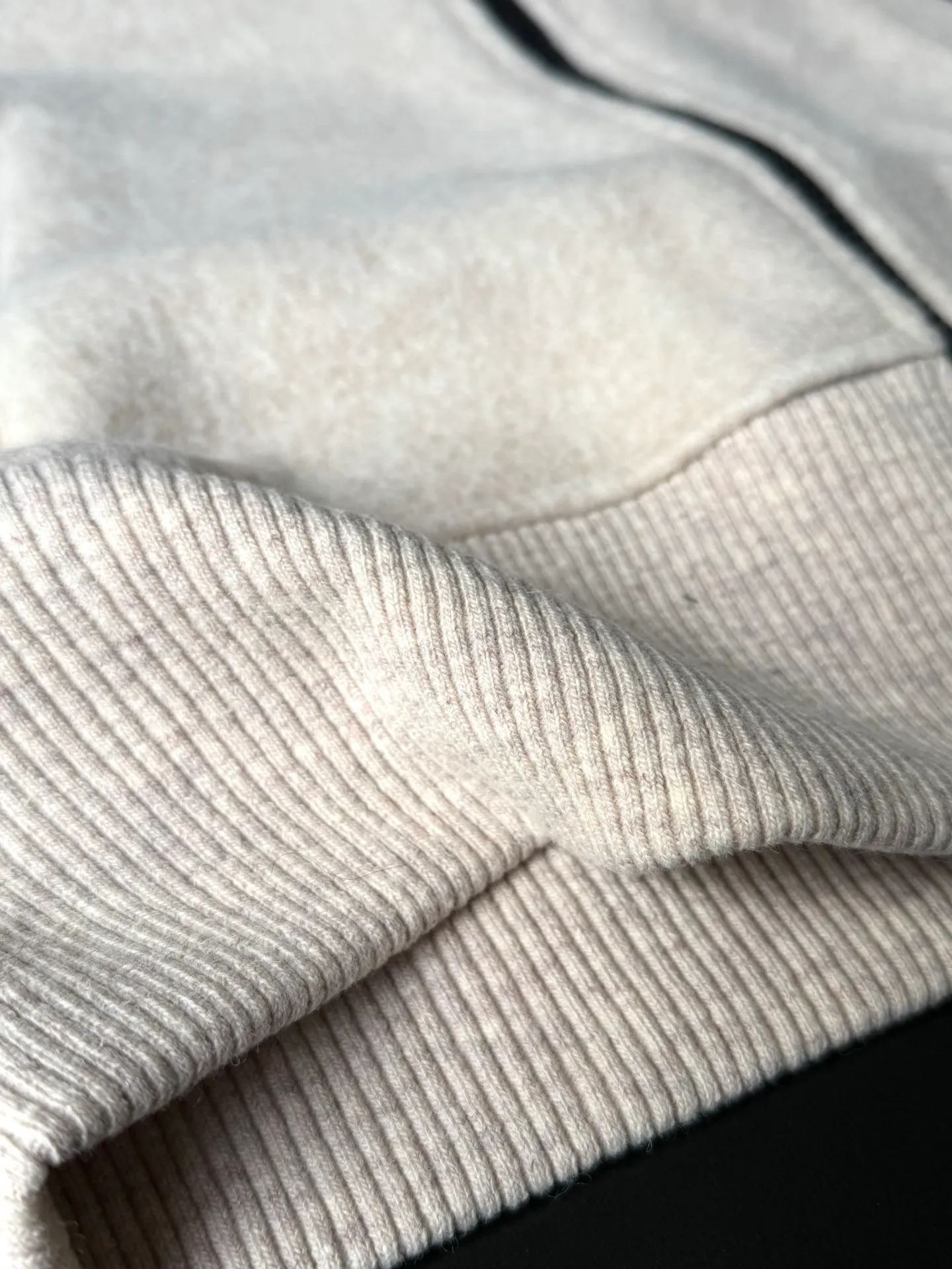 P620 Canada Goose Fleece Wool Baseball Jacket Fabric selection: Wool fleece fabric blended with wool as the main body and a very small amount of spandex and polyester fiber. Wool is a core natural ingredient that provides unparalleled temperature regulation, antibacterial and anti-odor properties and a skin-friendly feel. The feeding of a small amount of spandex gives the fabric a certain degree of four-way elasticity, making it non-restrictive during daily activities. As the basis of fleece's structure, polyester fiber enhances the fabric's durability, wrinkle resistance and quick-drying properties. It contributes to the loft of the fleece and provides functions such as trapping air.  Detail 1: The sleeves and hem are closed with 2×2 ribbing. Its strong elasticity can closely fit wrists and waists of different thicknesses, forming an effective 'seal' to prevent cold wind from blowing back. It can still maintain its original shape after repeated stretching and use, and is not easy to loose and deform. And the ribbed cuffs can convey a sense of design and enhance the visual beauty.  Detail 2: The combination of hood design and elastic buckle improves warmth and windproof performance when wearing. Accessories: Customized elastic drawstring, elastic buckle, custom zipper pendant, custom armband Size: S M L Color: Black Gray Mickey